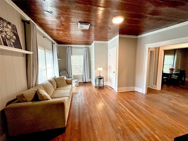 living room featuring ornamental molding, hardwood / wood-style flooring, and wooden ceiling