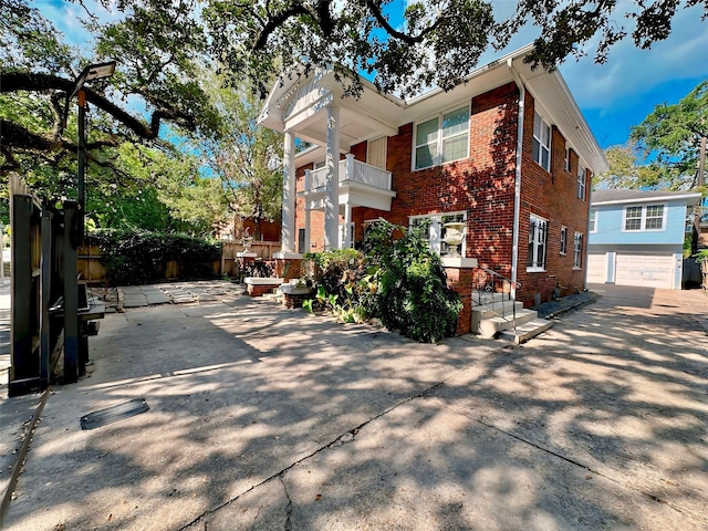 view of front of home featuring a garage and a balcony