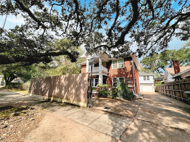 view of property exterior featuring a garage and a balcony