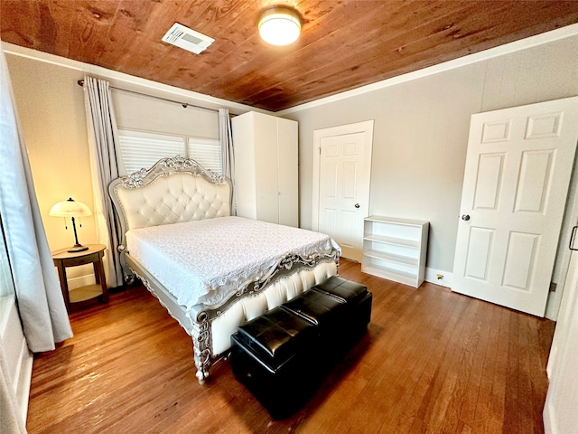 bedroom with wood ceiling and wood-type flooring