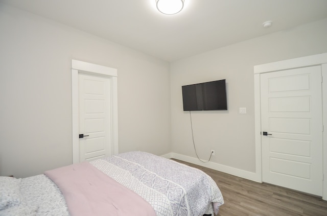 bedroom with wood-type flooring