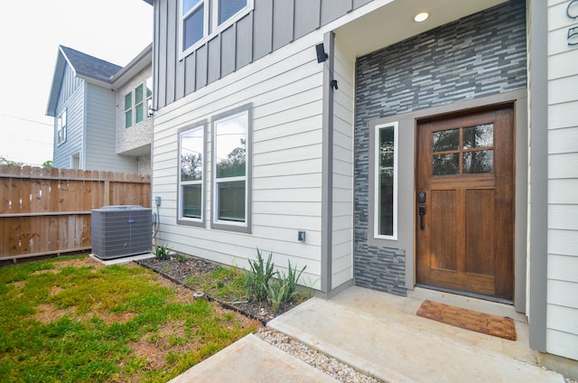 view of exterior entry featuring central AC unit