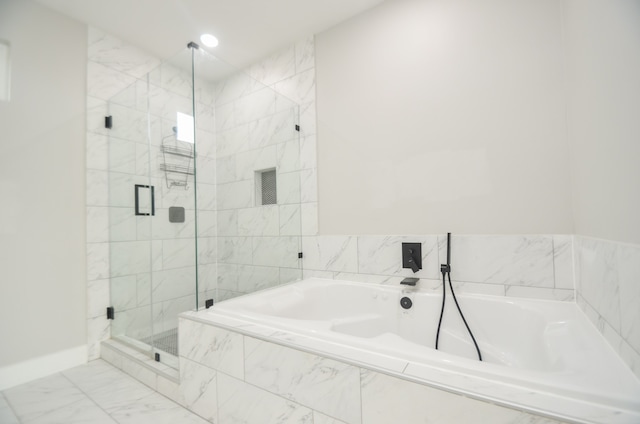 bathroom featuring shower with separate bathtub