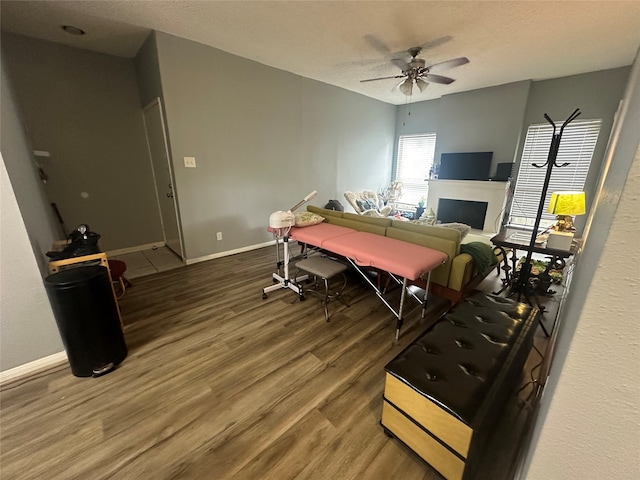 playroom featuring ceiling fan, wood-type flooring, and a textured ceiling