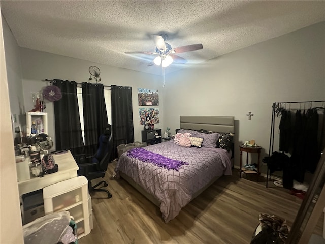 bedroom with wood-type flooring, ceiling fan, and a textured ceiling