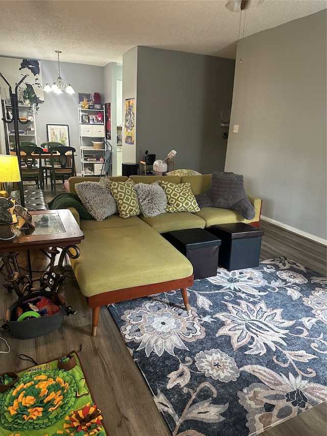 living room with dark wood-type flooring and a textured ceiling