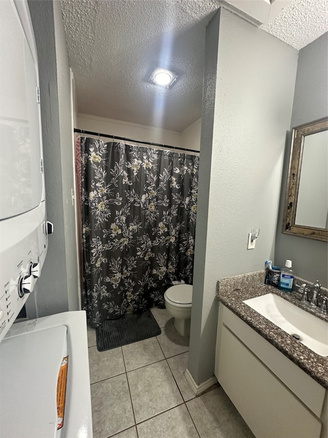 bathroom with vanity, tile patterned flooring, a textured ceiling, and toilet