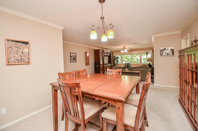 carpeted dining area with ornamental molding and ceiling fan with notable chandelier