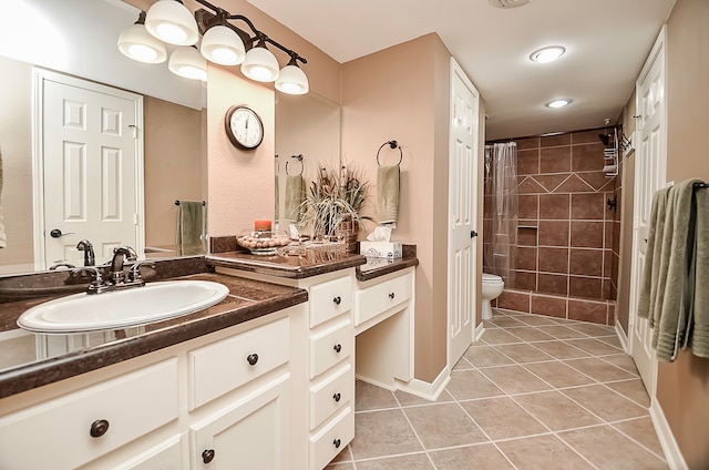 bathroom with toilet, vanity, a shower with shower curtain, and tile patterned floors