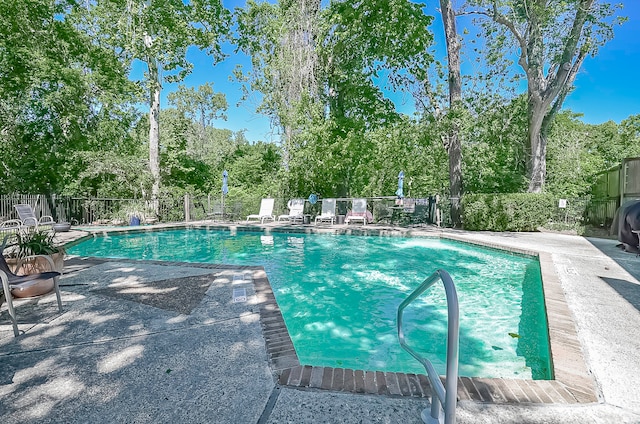 view of swimming pool featuring a patio area