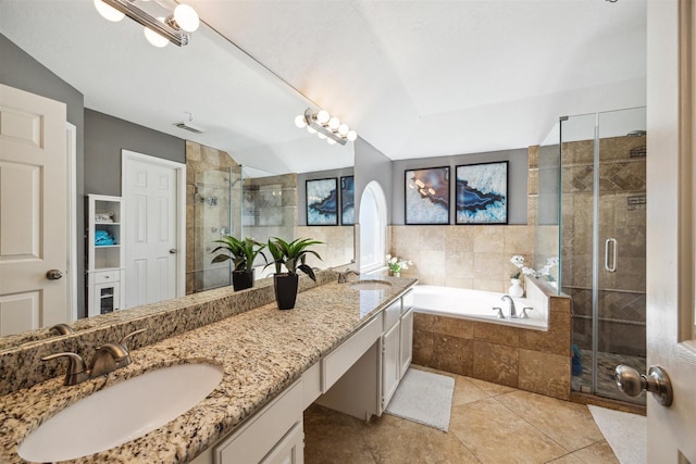 bathroom with tile patterned floors, vanity, lofted ceiling, and plus walk in shower