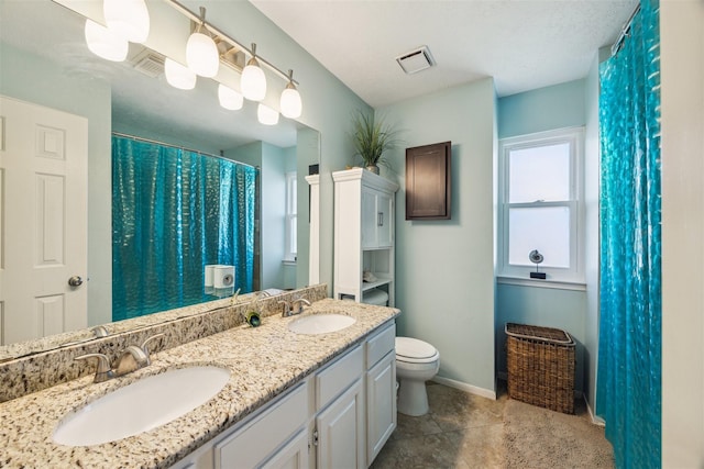 bathroom with tile patterned floors, vanity, and toilet