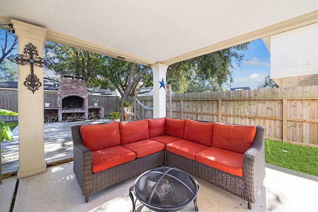 view of patio with an outdoor living space with a fireplace