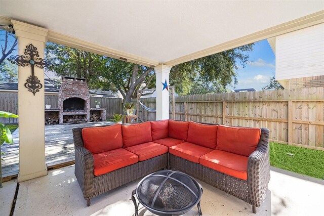 view of patio with an outdoor living space with a fireplace