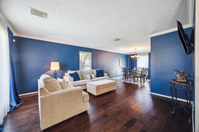 living room featuring dark hardwood / wood-style flooring, crown molding, plenty of natural light, and a textured ceiling