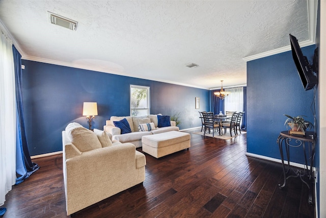 6210 W Willow Bluff Rd, Katy, TX 77449 - living room with a textured ceiling, a chandelier, baseboards, crown molding, and wood finished floors