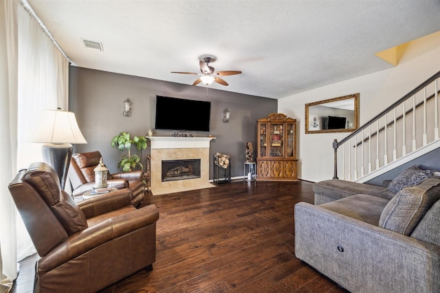 living room with ceiling fan, dark hardwood / wood-style floors, and a fireplace