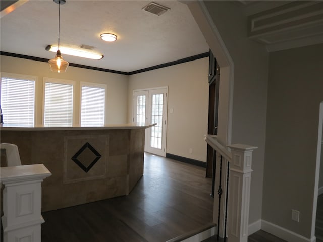 kitchen with ornamental molding, decorative light fixtures, dark hardwood / wood-style floors, and french doors