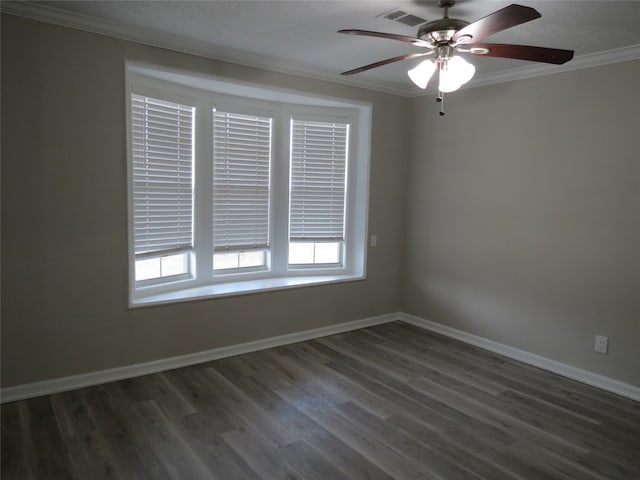 empty room featuring dark wood-type flooring, ceiling fan, and crown molding