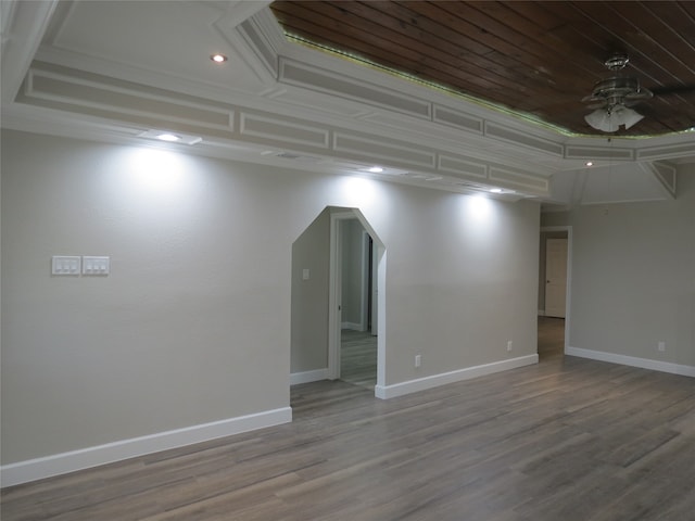 empty room with ornamental molding, wood-type flooring, and ceiling fan