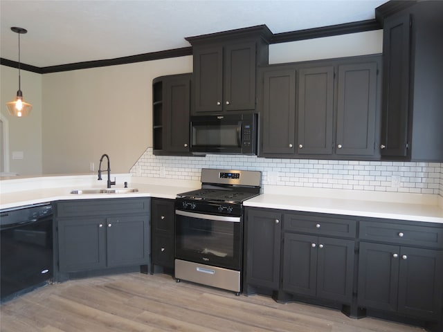 kitchen featuring light hardwood / wood-style floors, black appliances, sink, tasteful backsplash, and decorative light fixtures