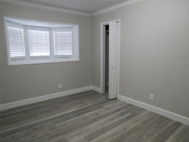 unfurnished bedroom with dark wood-type flooring and ornamental molding