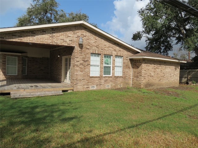 view of property exterior featuring a wooden deck and a yard