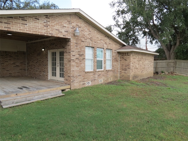 exterior space featuring a yard, french doors, and a wooden deck