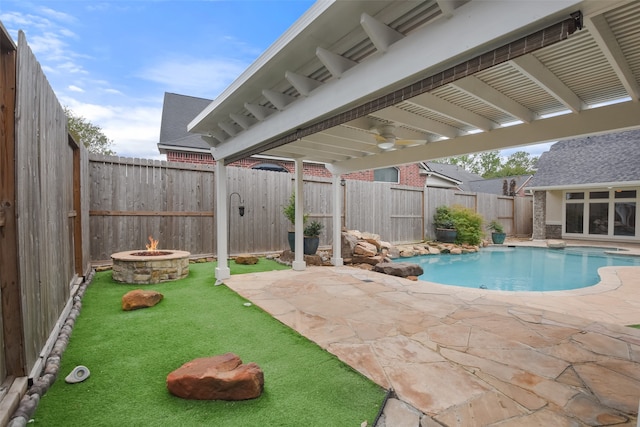 view of pool with an outdoor fire pit and a patio area