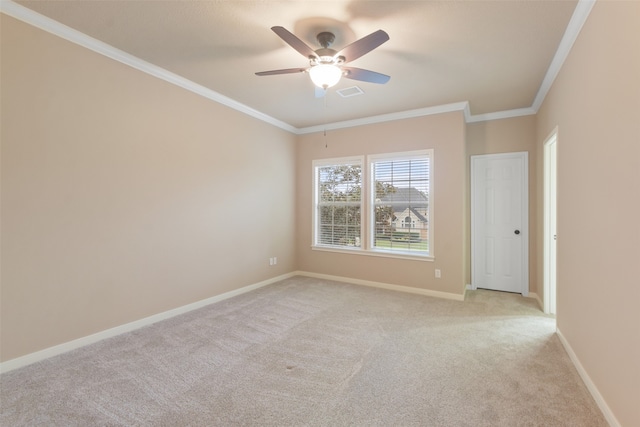 carpeted spare room featuring ornamental molding and ceiling fan