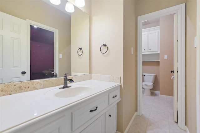 bathroom with vanity, tile patterned flooring, and toilet