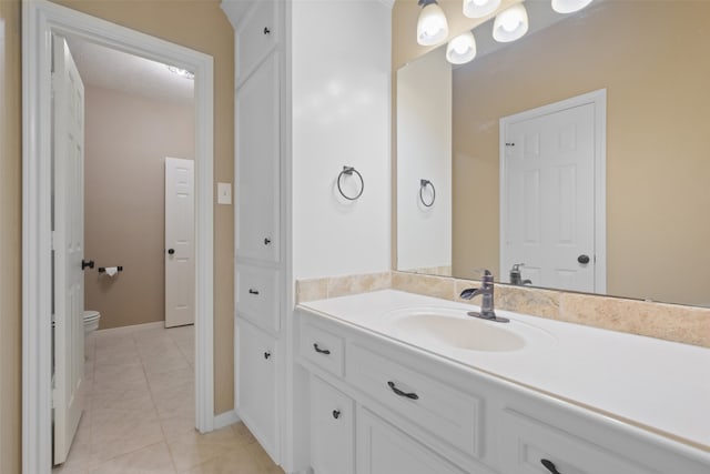 bathroom featuring toilet, vanity, and tile patterned floors