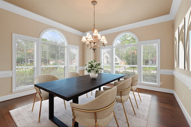 dining room featuring dark hardwood / wood-style floors, an inviting chandelier, and crown molding