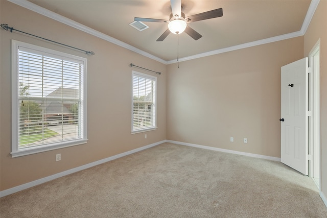 empty room with ornamental molding, light colored carpet, and ceiling fan