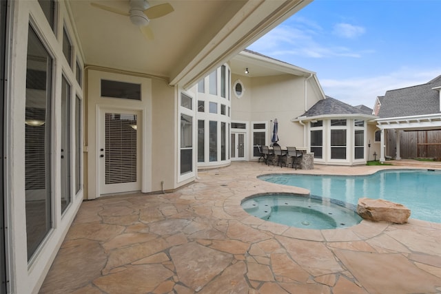 view of swimming pool with a patio, ceiling fan, and an in ground hot tub