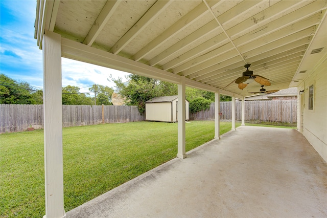 view of yard featuring a shed, ceiling fan, and a patio