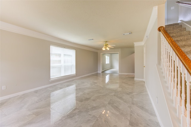 unfurnished room featuring ceiling fan and crown molding