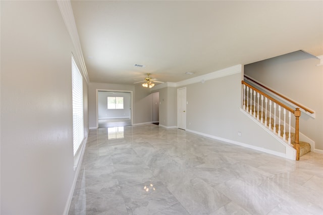 unfurnished living room featuring ceiling fan and crown molding