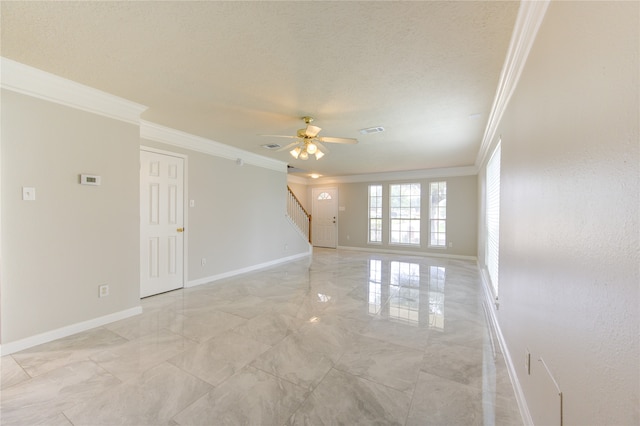 unfurnished room with ceiling fan, a textured ceiling, and crown molding