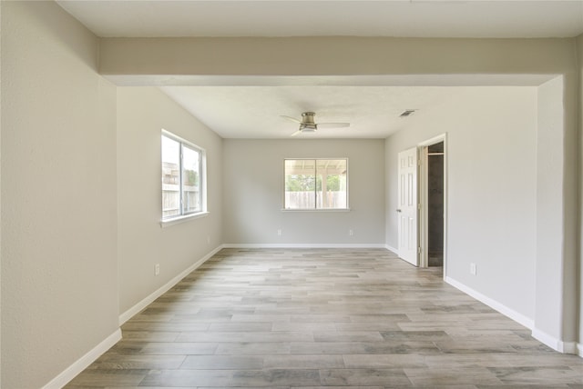 empty room with light wood-type flooring and ceiling fan