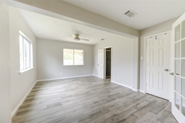 unfurnished bedroom featuring light hardwood / wood-style floors, ceiling fan, and a closet