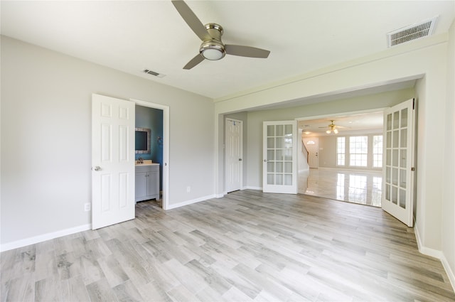 unfurnished room featuring french doors, light hardwood / wood-style floors, and ceiling fan