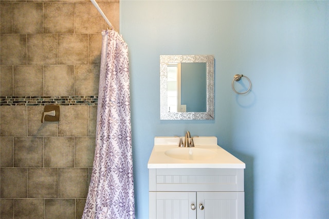 bathroom with walk in shower and vanity