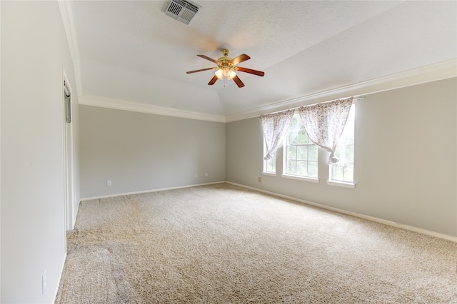 spare room with ceiling fan, vaulted ceiling, light colored carpet, and ornamental molding