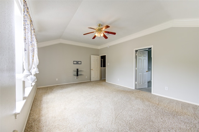 carpeted empty room with ceiling fan, crown molding, and vaulted ceiling