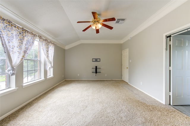 spare room featuring ornamental molding, vaulted ceiling, carpet flooring, and ceiling fan