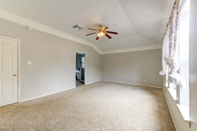 carpeted spare room featuring ornamental molding, lofted ceiling, and ceiling fan