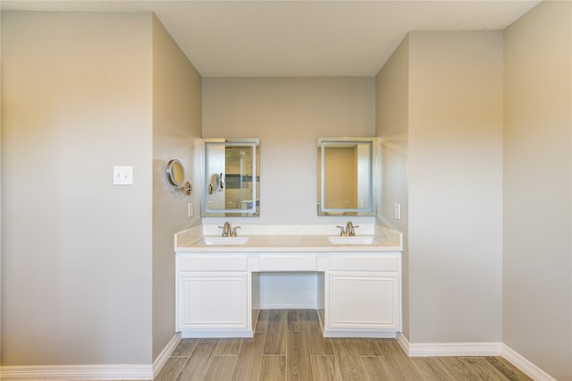 bathroom featuring hardwood / wood-style flooring and vanity