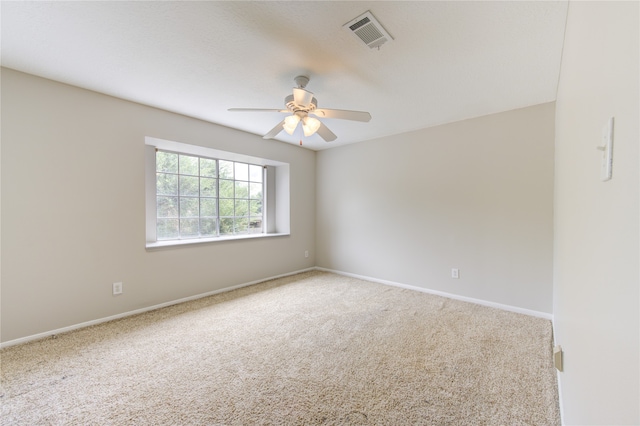 carpeted empty room featuring ceiling fan