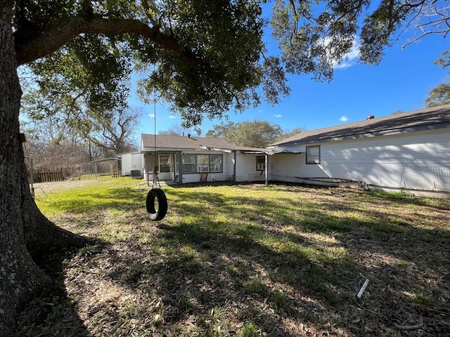 back of property featuring a yard